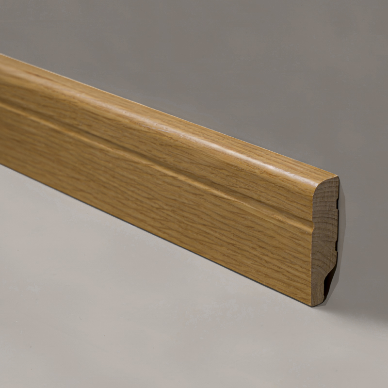Close-up of solid wood skirting board grain and profile edge